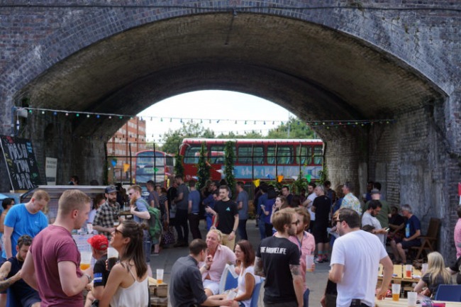 People drinking in the arches next to The Five Points Brewing Company warehouse in Hackney