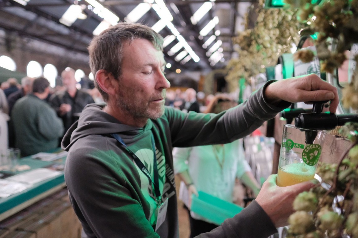 A man pouring a pint of beer at theKent Green Hop Festival